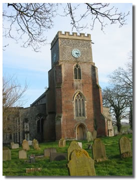 Denton Church tower, built out of brick and flint with a clock mounted high up
